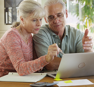 Senior couple using laptop computer.