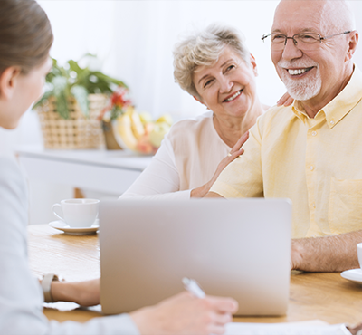Happy seniors with insurance agent.